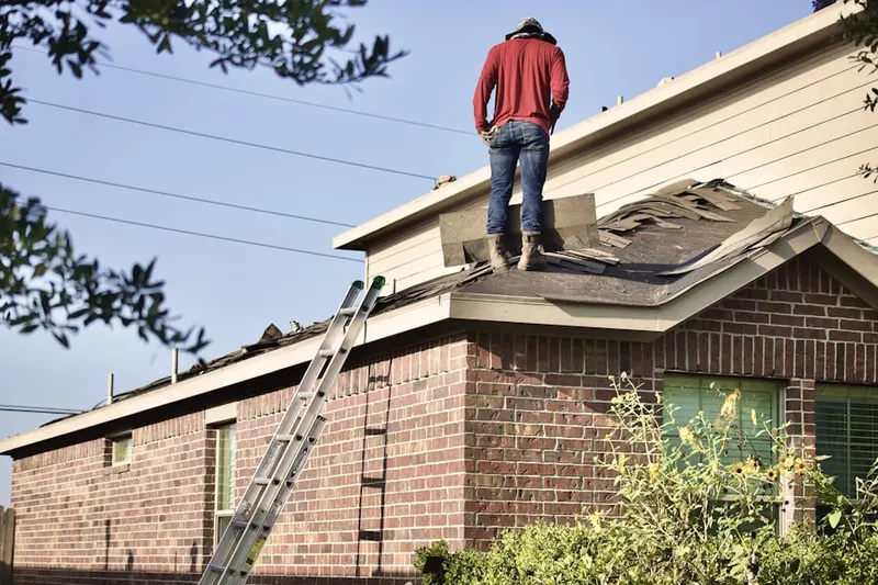 Professional roofer working on a residential roof in Mission